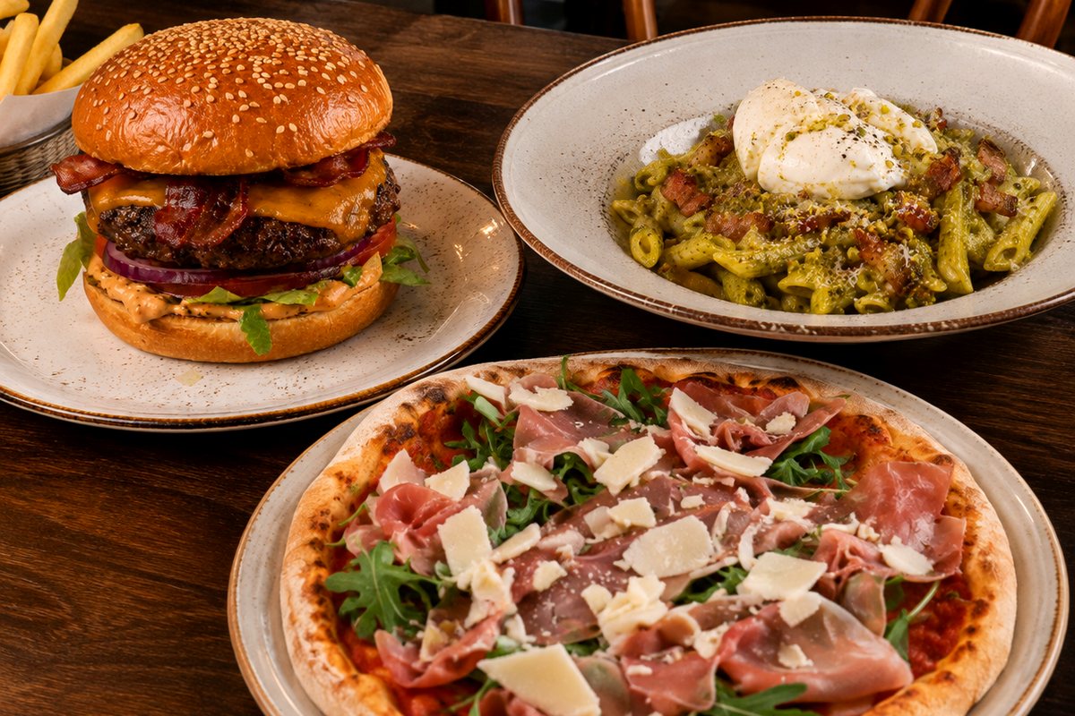 A bacon cheeseburger with fries, penne in pistachio pesto with burrata, and a Parma pizza